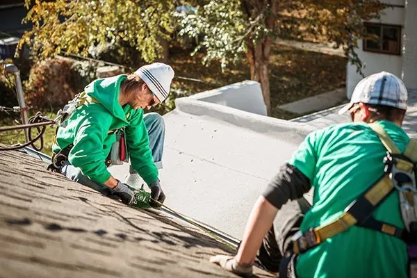 Roofing contractors working on a house roof